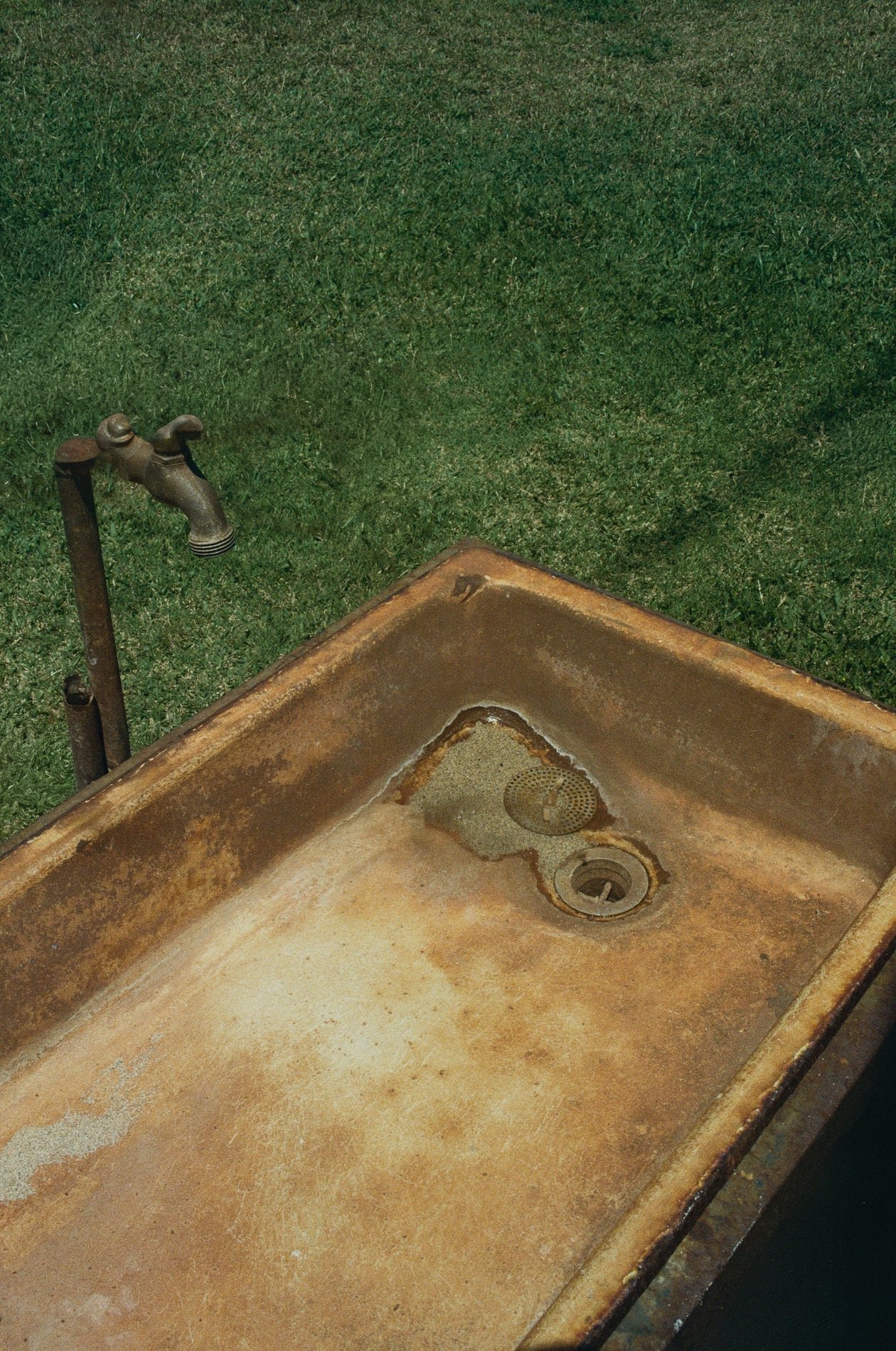 Weathered outdoor sink on grass