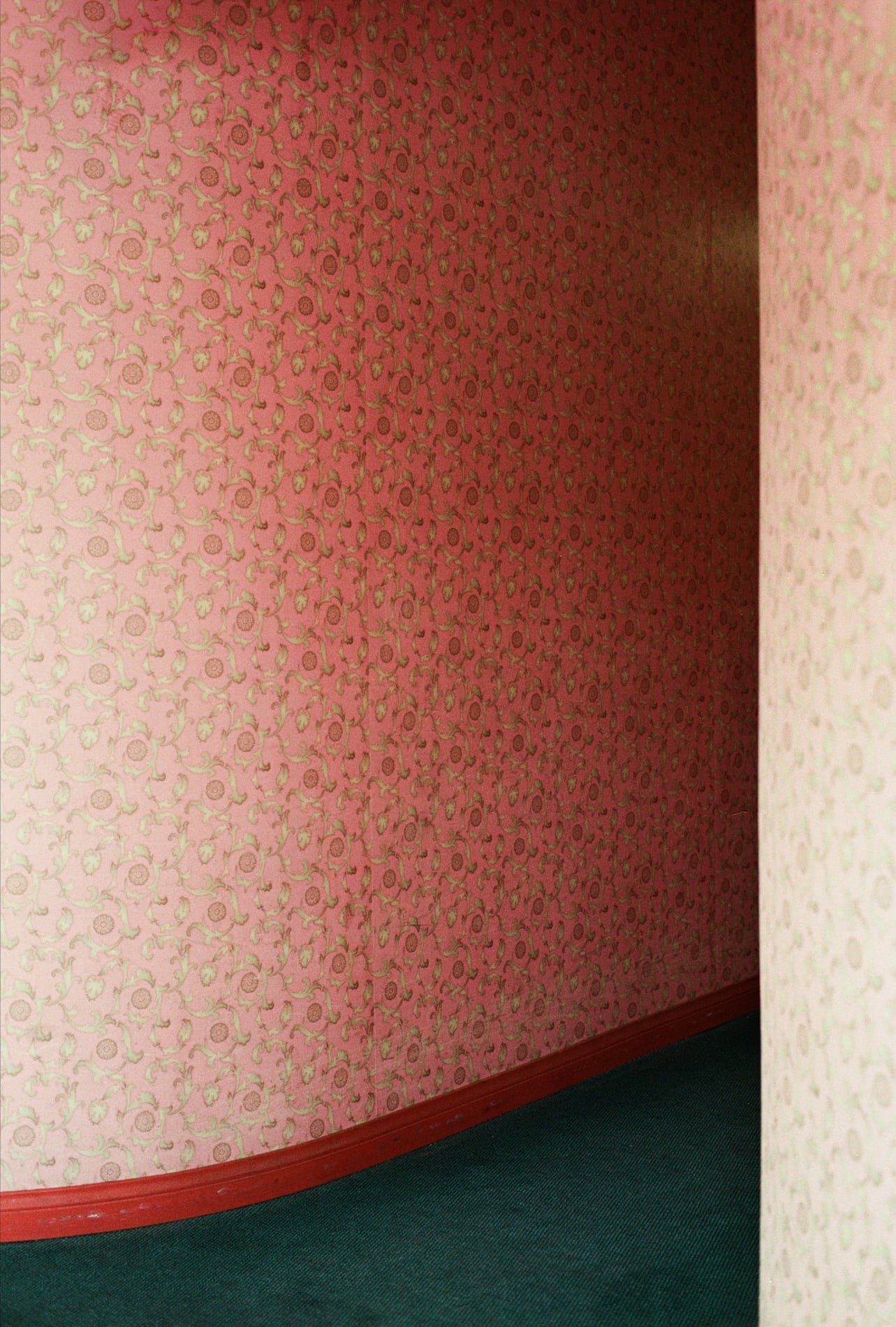 Pink wallpapered hallway